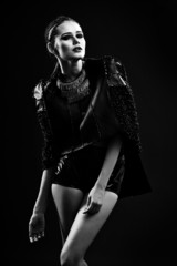 Beautiful young woman in leather jacket. Black-white photo