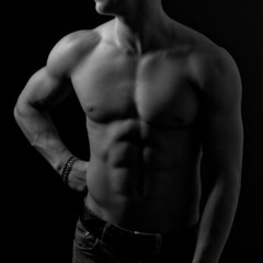 Fototapeta na wymiar Perfect male body on black background.