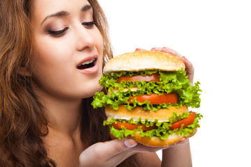 Happy Young Woman Eating big yummy Burger isolated