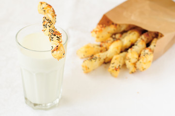 Puff Pastry Sticks in a Paper Bag with a Glass of Milk, copy spa