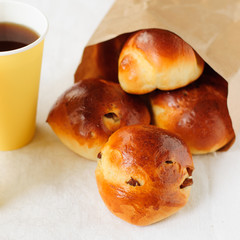 Sultana Buns in a Paper Bag with a Cup of Coffee, copy space for