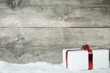 Gift box on an old wooden background with snowflake - 57492102