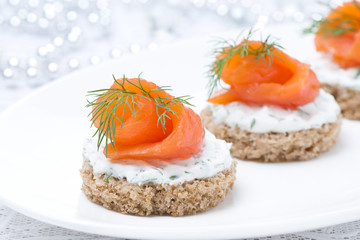 canape with rye bread, cream cheese, salmon and greens