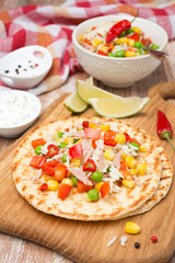 colorful vegetable salad with tuna on wheat tortillas