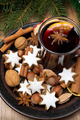 cookies in the shape of stars, spices and mulled wine on a plate