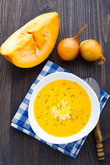 Pumpkin soup in white bowl