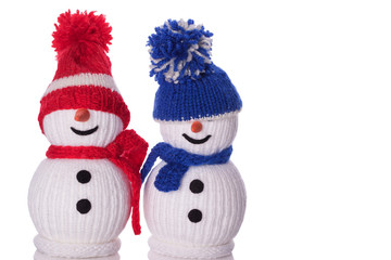 couple of snowman with red and blue hat and scarf