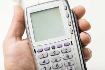 The modern bank terminal in a man's hand