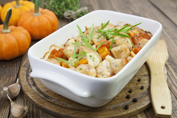 Baked pumpkin with chicken. garlic and herbs