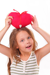 Smiling little girl with a red heart