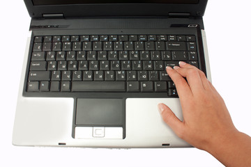 hand pressing the "enter" on the laptop