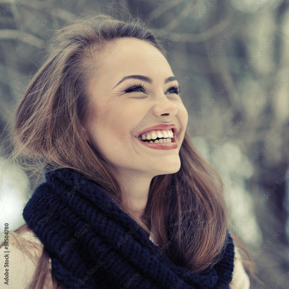 Wall mural Young beautiful laughing girl in winter - close up