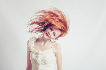 red haired expressive emotional female with flying hair 