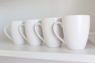 white cups on the shelf