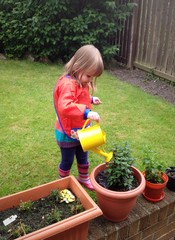 child watering plants