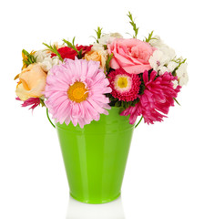 Beautiful bouquet of bright flowers in color vase, isolated