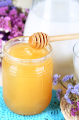 Honey and milk on wooden table close-up