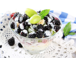 Fruit salad in glass bowl, isolated on white