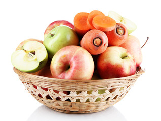 Sweet apples and carrots in basket isolated on white