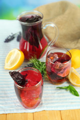 Red basil lemonade in jug and glass,