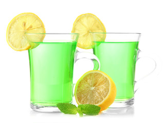 Two transparent cups of green tea with mint and lemon isolated