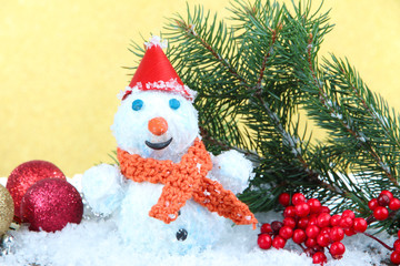 Beautiful snowman and Christmas decor, on golden background