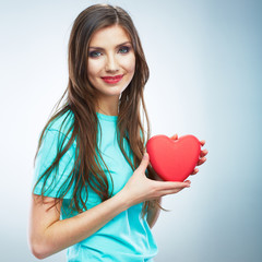 Red heart. Love symbol. Portrait of beautiful woman hold Valent