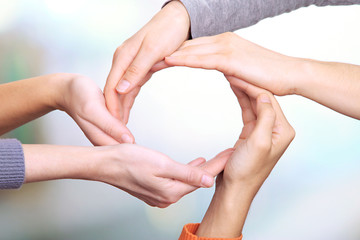 Human hands making circle on bright background