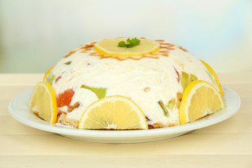 Delicious jelly cake on table on light background