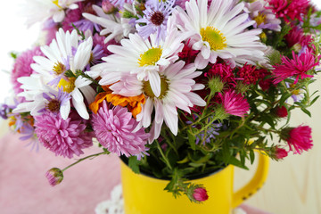 Wildflowers in mug on napkin on wooden table