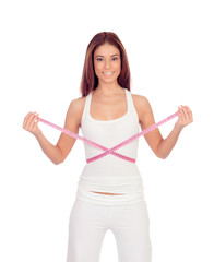 Fototapeta na wymiar Attractive happy girl with a tape measure measuring her waist