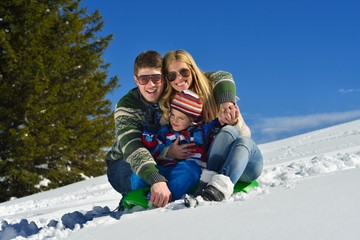 Fototapeta na wymiar family having fun on fresh snow at winter