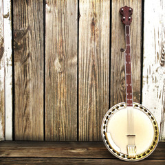 Banjo leaning on a wooden fence. Room for advertisment - obrazy, fototapety, plakaty