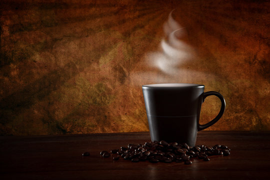 coffee mug with hot stream on vintage brown background