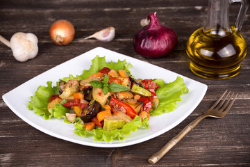 Roasted vegetables on a white plate, close up
