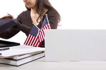State or Federal female worker with a blank sign on her desk