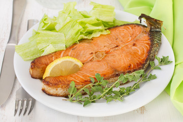 fried fish with lemon and lettuce