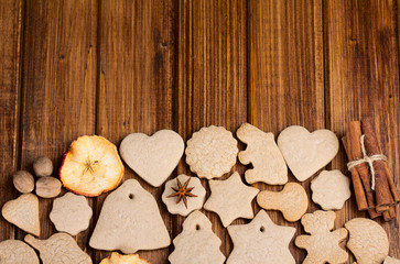 Homemade christmas cookies and spice  on wooden background