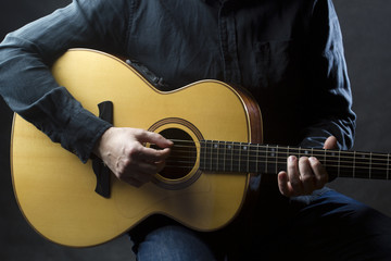 Playing acoustic guitar