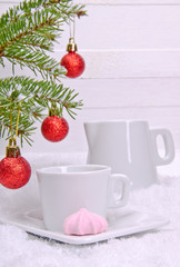 Meringue and white cup with a milkman