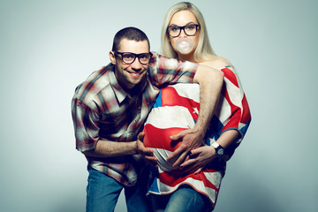 Obraz premium Happy american family (pregnancy) concept: two funny hipsters