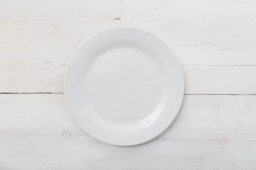 Weisser Teller auf hellem Holz