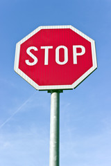 Stop road traffic sign over blue sky
