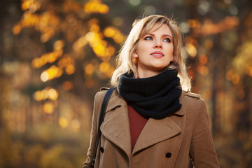 Happy blond woman in autumn forest