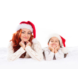 A happy mother and a daughter in Christmas hats
