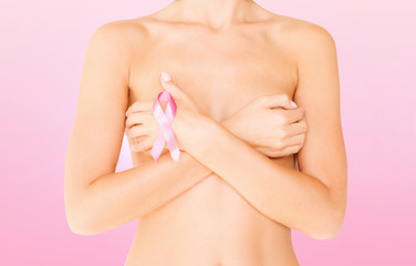 Obraz na płótnie Canvas naked woman with breast cancer awareness ribbon