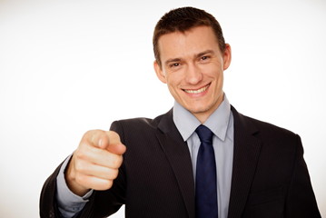 Young businessman at suit pointing at you.