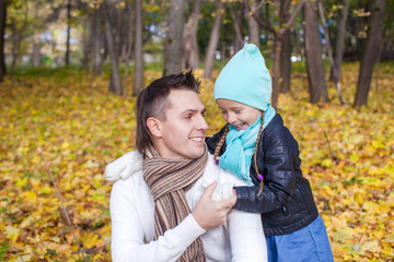 Fototapeta premium Happy dad and his little girl having fun in the park on a sunny