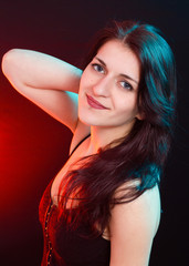 Naklejka premium Natural beauty brunette woman in red and blue light