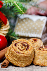 Fototapeta na wymiar Cinnamon rolls in christmas setting. Selective focus